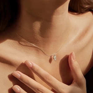 Marquise cut moissanite pendant on invisible fishing line chain shown on a model neck