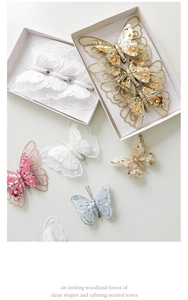 Assorted colorful sequin butterfly hair clips with lace and pearls on a cream background