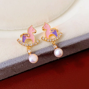 Detail of rocking horse earrings with pink enamel, sparkling crystals and pearl drop