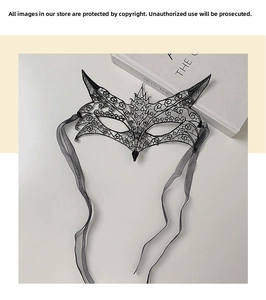 Close-up of black lace masquerade mask with intricate embroidery and fox-style hollow design