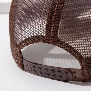 Detail of brown mesh trucker hat showing adjustable plastic snapback closure on the back