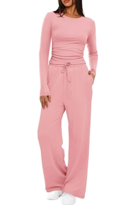 Dettaglio di maglia rosa a maniche lunghe e pantaloni a gamba larga con coulisse