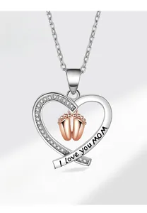 Macro detail of heart pendant with rose gold baby feet and I love you MOM engraving