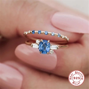 Detailed macro view of 925 sterling silver rings with blue oval stone and zircon accents