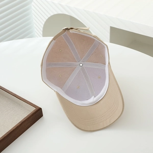 Detailed interior of a khaki cotton baseball cap showing reinforced seams and metal buckle