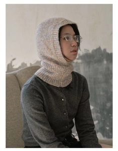 Close-up of a colorful speckled knit balaclava hood featuring soft textured wool yarn