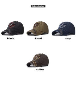Detailed close-up of four colors of washed denim baseball caps with Texas cattle embroidery