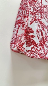 Detailed close-up showing precision stitching on red and white jacquard tote bag