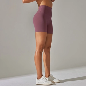 Detailed side view of high-waisted dark purple yoga shorts with a seamless sleek design