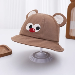 Detail showing brown baby bucket hat with cute 3D ears and cartoon eye embroidery
