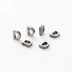 Detailed view of D-shaped antique silver metal beads with 1.8mm holes for DIY jewelry
