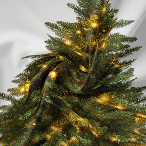 Detailed view of bohemian Christmas tree tapestry with warm star light patterns and soft texture