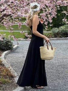 Chic black cotton maxi dress with high waist and A-line silhouette for summer vacation