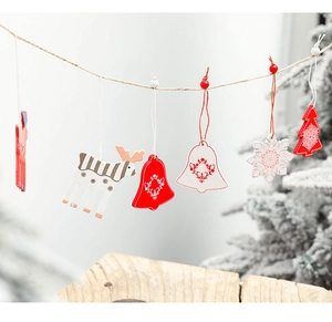 Detailed close-up of festive wooden reindeer and snowflake ornaments on a rustic hemp rope