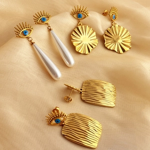 Evil eye fringe earrings set in 18K gold plated stainless steel with pearl tassels