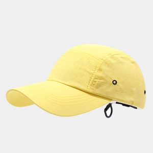 Detail of yellow quick-dry 5-panel cap with metal eyelet and black elastic toggle