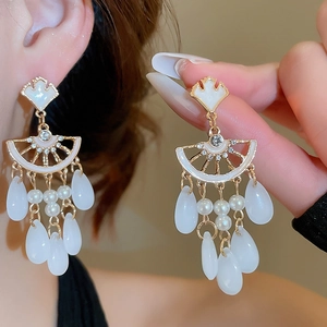 Detailed view of ginkgo leaf tassel earrings with pearls and crystals in vintage style
