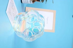 Detailed view of cat paw shaped iridescent glass ashtray with rainbow metallic finish
