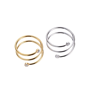 Elegant spiral pavé ring in gold and silver finish with zircon stones on white background