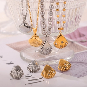 Shell shaped jewelry set with freshwater pearls and diamonds in gold and silver finish