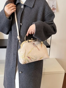 New Chinese-style handbag with bird and bamboo leaf embroidery shown with a grey coat