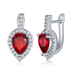 Detailed view of pear-cut red zircon drop earrings with silver pave settings