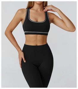 Detail of black sports bra with white piping and high-elastic moisture-wicking fabric