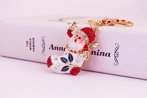 Close-up of Santa Claus in Christmas stocking keychain with colorful rhinestones and gold chain