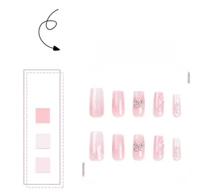 Detail view of pink gradient press-on nails with 3D bows, rhinestones and glitter finish