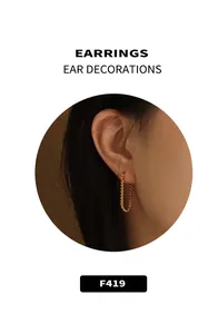 Close-up of vintage gold-plated twist earrings worn by model on a textured backdrop