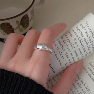 Close-up of 925 sterling silver croissant ring on finger with elegant aesthetic style