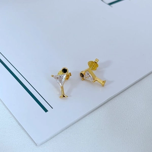 Detailed view of martini glass stud earrings with white zirconia in gold finish
