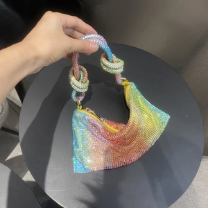 Rainbow rhinestone baguette bag with colorful gradient crystals and knotted handle detail