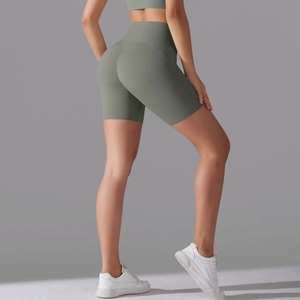 Close-up of high-waisted yoga shorts in sage green with seamless push-up design
