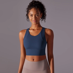 Front view of navy blue sports bra with thick straps and high-waist taupe yoga leggings