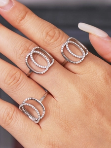 Macro detail of double-layered open rings with cubic zirconia pavé on a silver band