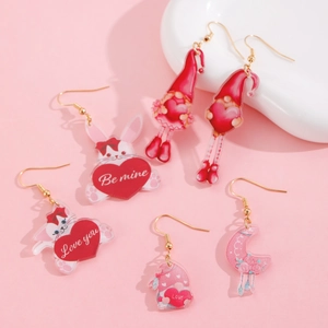 Detailed close-up of colorful acrylic Valentine earrings with heart, bear and gnome patterns