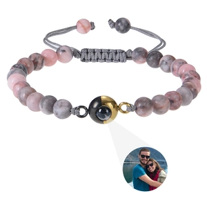 Detail of custom photo projection bracelet with natural tiger eye stones and braided rope