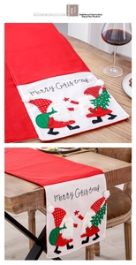 Detail of red and white felt Christmas table runner with Merry Christmas gnome embroidery