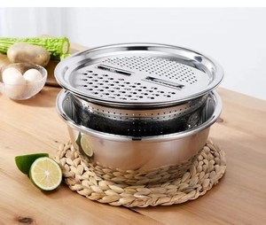 Three-piece stainless steel kitchen set with grater, strainer, and mixing bowl on wood