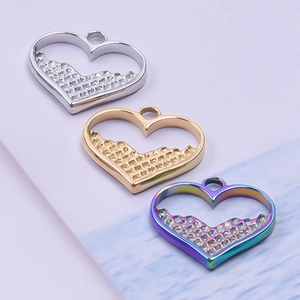 Detailed view of heart-shaped pendants in silver, gold, and rainbow stainless steel