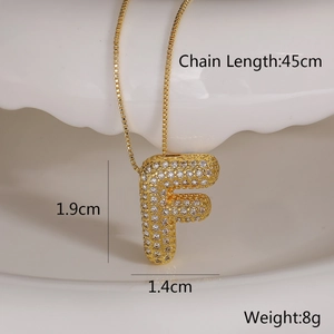 Detail view of gold letter F pendant with dimensions 1.9cm height and 45cm chain length