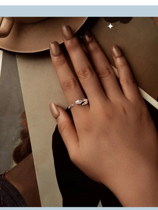 Close-up of a s925 silver tulip open ring with pink enamel detail worn on a finger