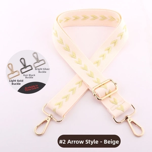 Beige woven bag strap with green arrow patterns and adjustable metal hardware detail