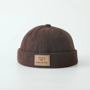 Dark brown striped knit miki hat for kids featuring a cute bear leather patch detail