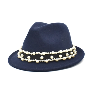 Close-up of deep blue wool fedora featuring an elegant faux pearl beaded hatband decoration