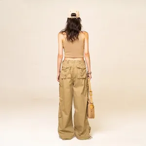 Back view of khaki wide-leg cargo pants and knitted crop top in a minimalist studio