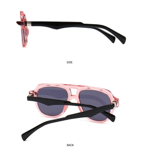 Side and back view of retro oversized sunglasses with pink transparent frames and black temples