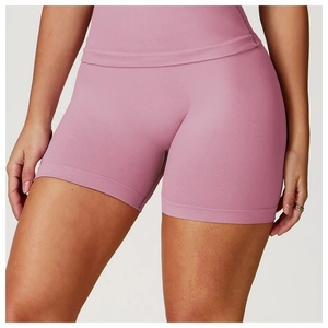 Detail of high-waist seamless yoga shorts in dusty pink with wide waistband and knit texture