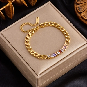 Detail of Cuban chain bracelet in gold finish with colorful rectangular zircon stones